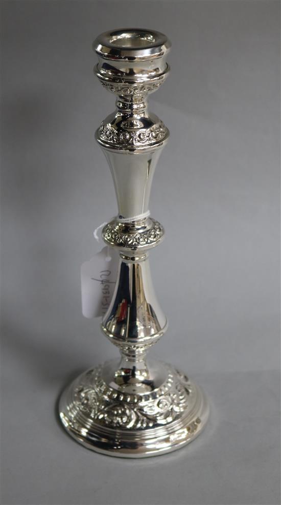 A modern silver candlestick with foliate decoration, W.I. Broadway & Co, Birmingham, 1974, 25.7cm.